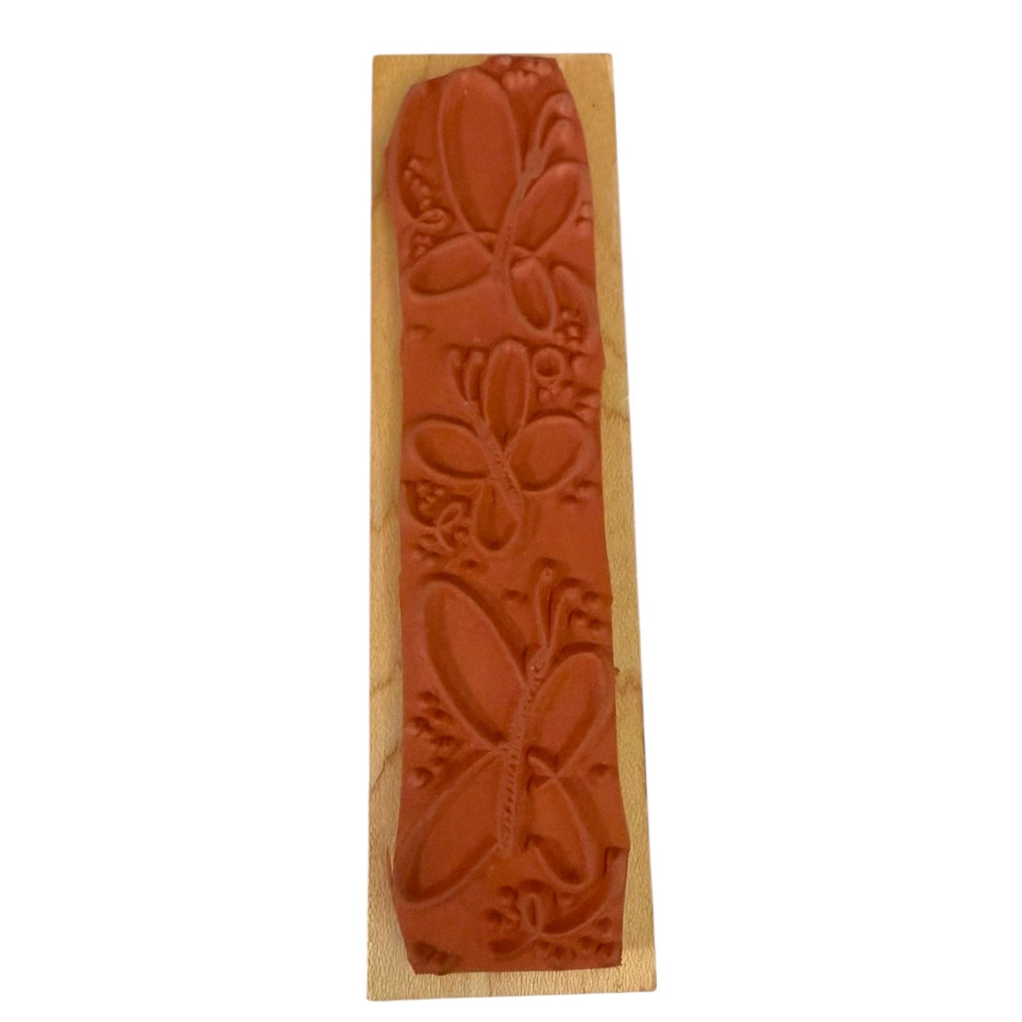 Wooden stamp with butterfly design on a white background