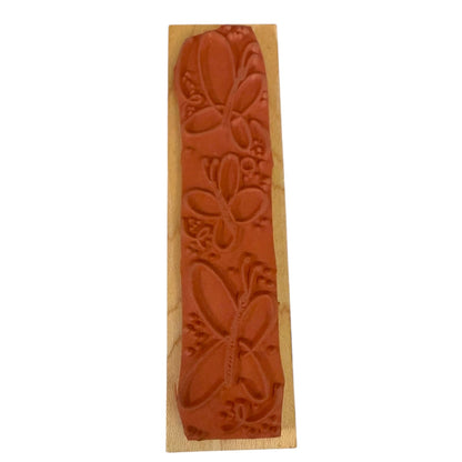 Wooden stamp with butterfly design on a white background