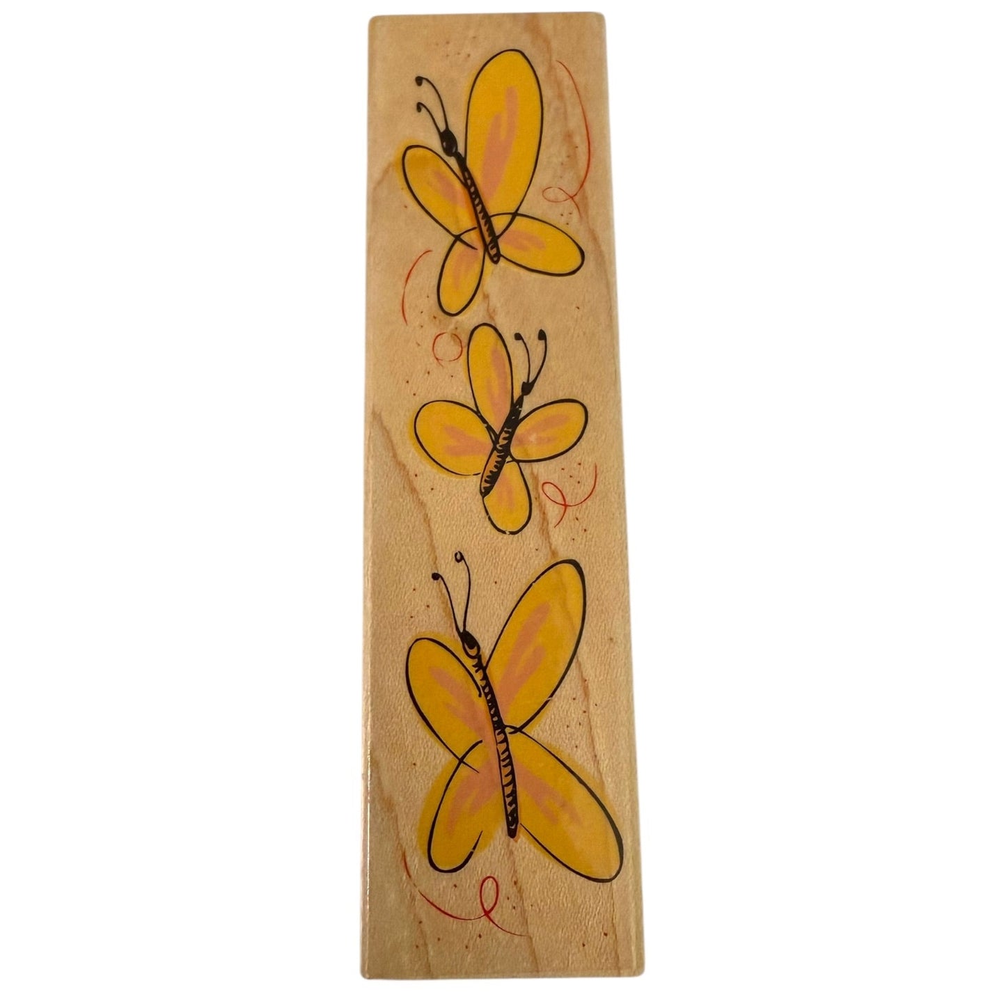 Wooden stamp with three yellow butterflies on a white background