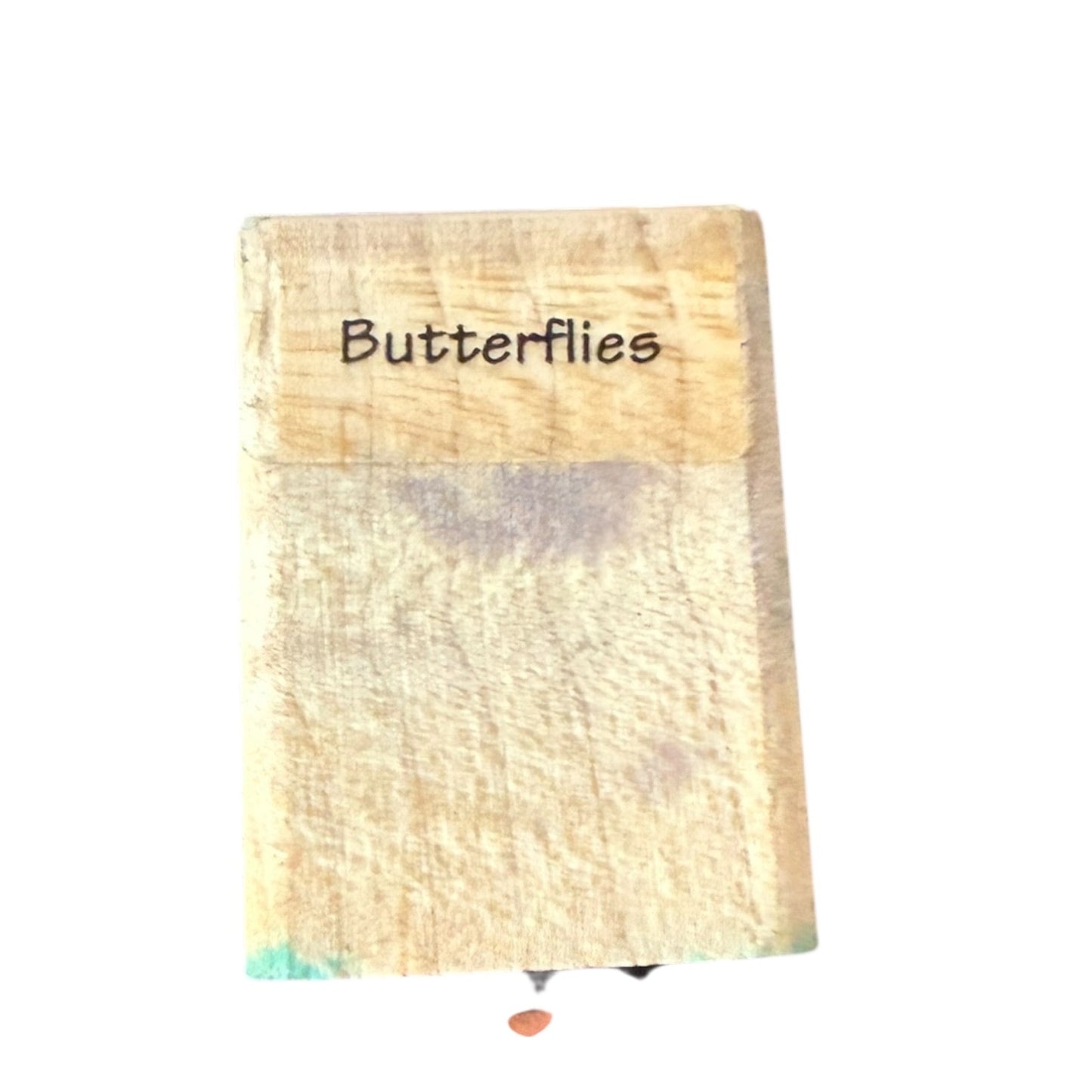 Wooden block with 'Butterflies' text on a white background