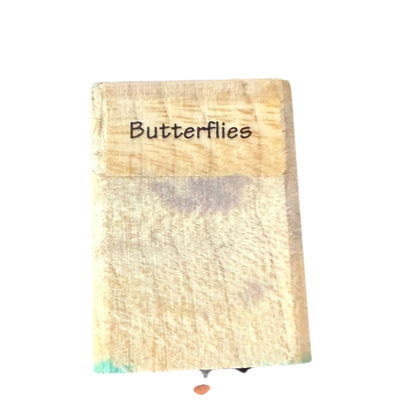 Wooden block with 'Butterflies' text on a white background