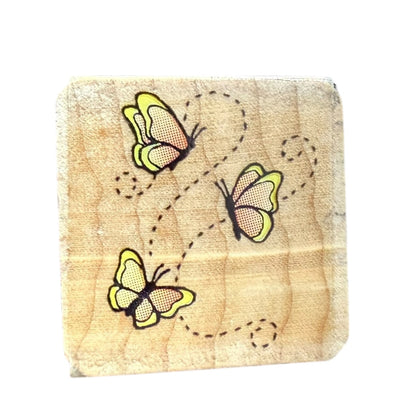 Wooden block stamp with butterflies on a white background
