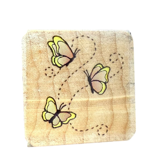 Wooden block stamp with butterflies on a white background