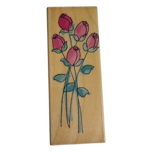 Wooden block with pink roses and green leaves on a white background