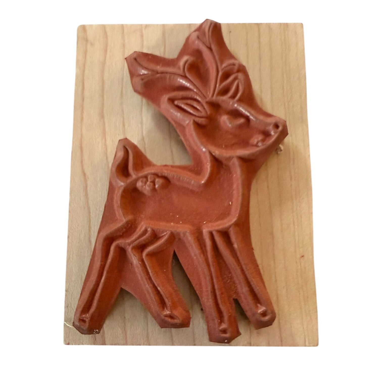 A reddish reindeer stamp light wood block, shown against a plain white background.