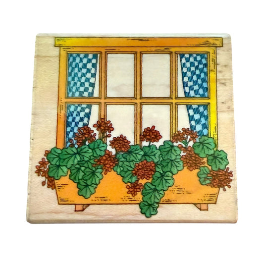 Decorative wooden panel stamp with a window and flower box design on a white background