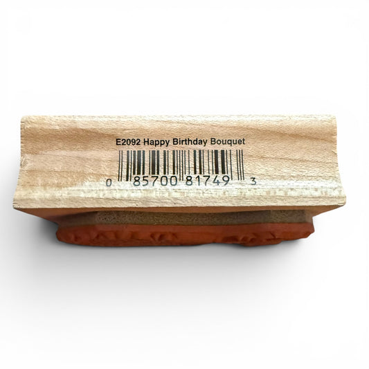Wooden stamp with 'Happy Birthday Bouquet' text and barcode on a white background