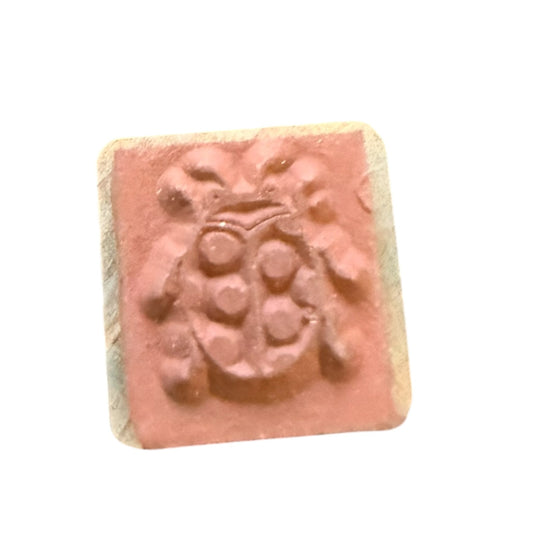 Rubber stamp with lady bug design on a white background