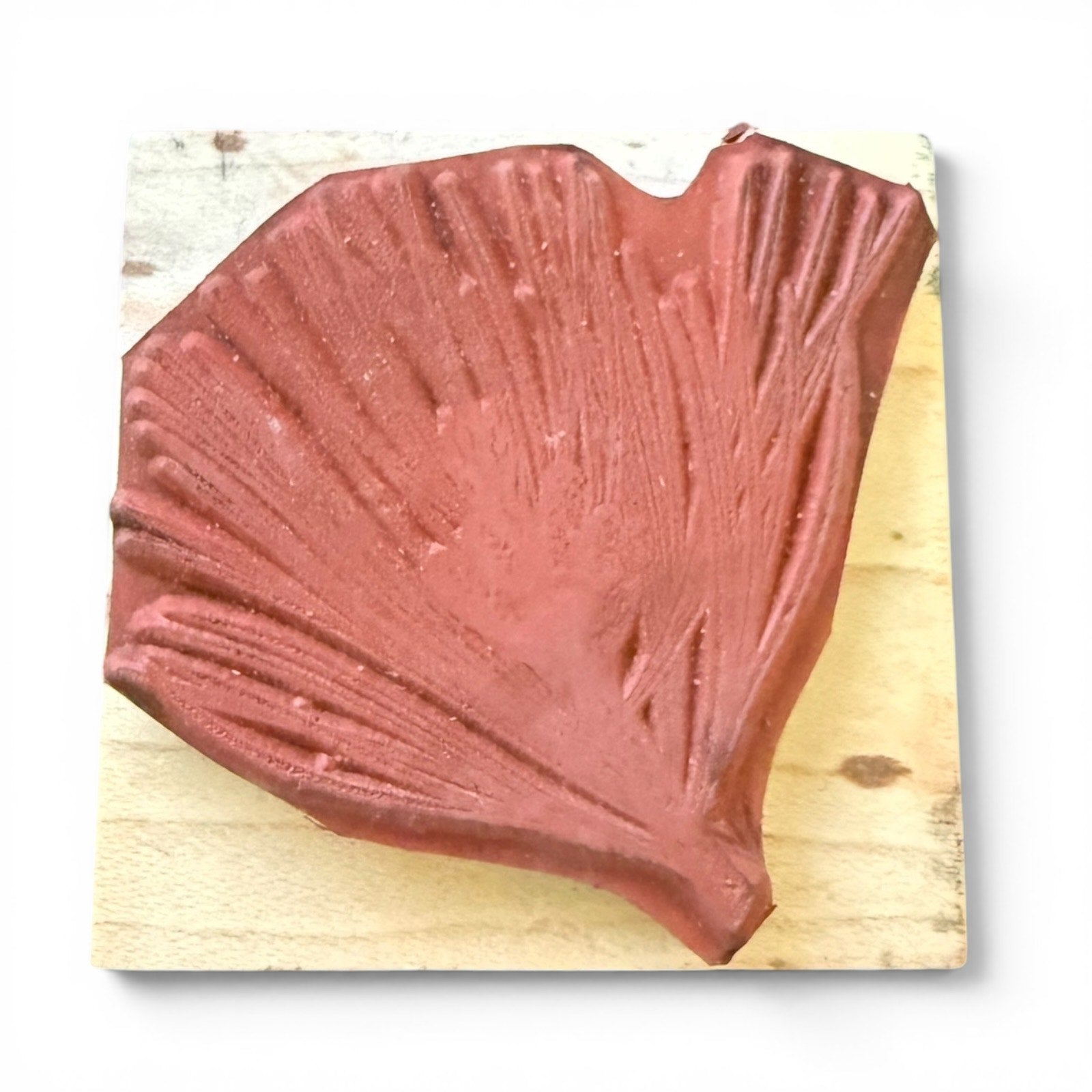 Red stamp on a wooden surface