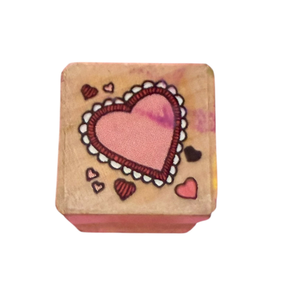 Multi heart stamp with a wood block on a white background. 