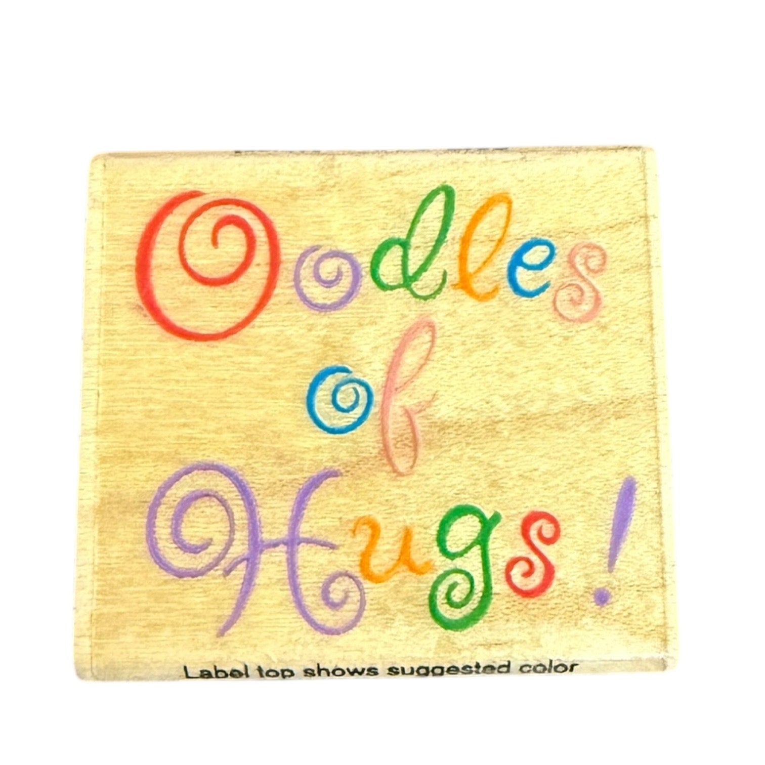 Stamp with Colorful text 'Oodles of Hugs!' on a yellow label with a white background