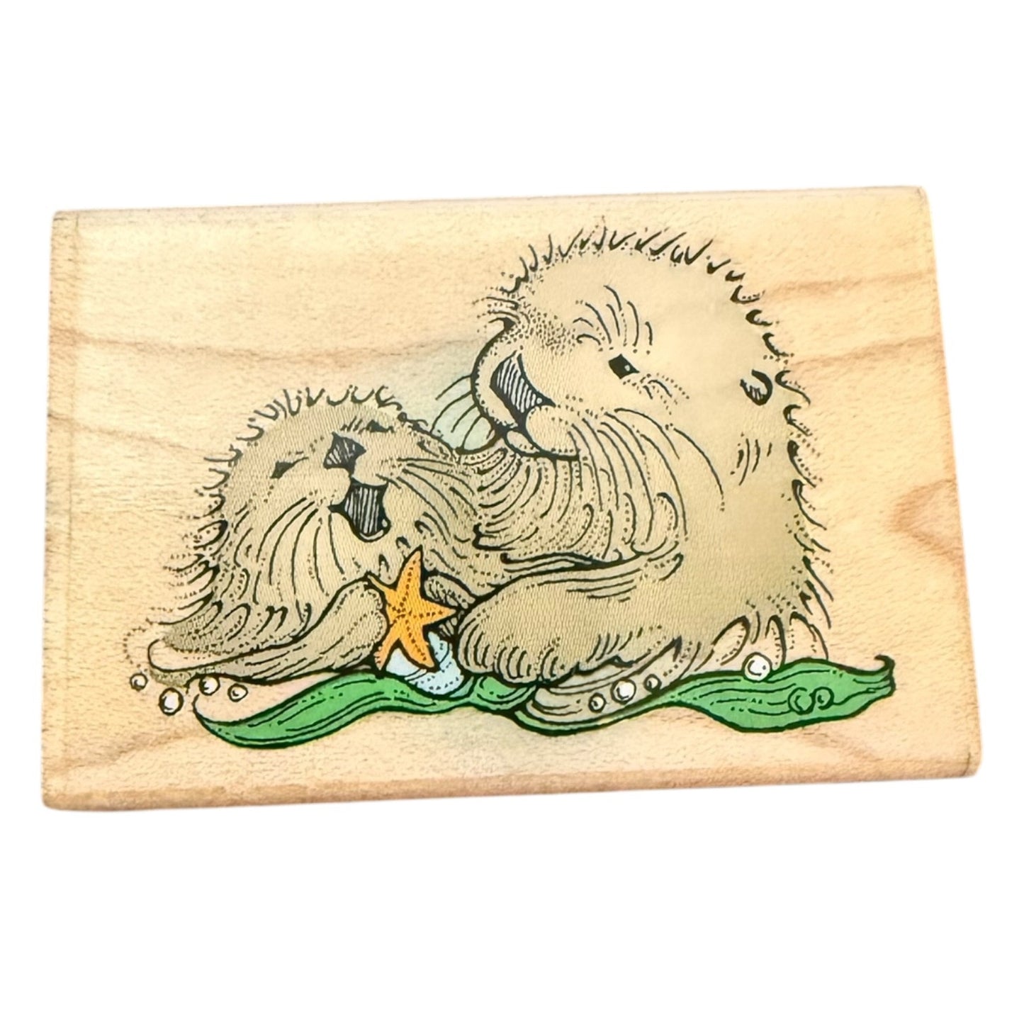 Wooden stamp with a design of a otters and starfish on a white background