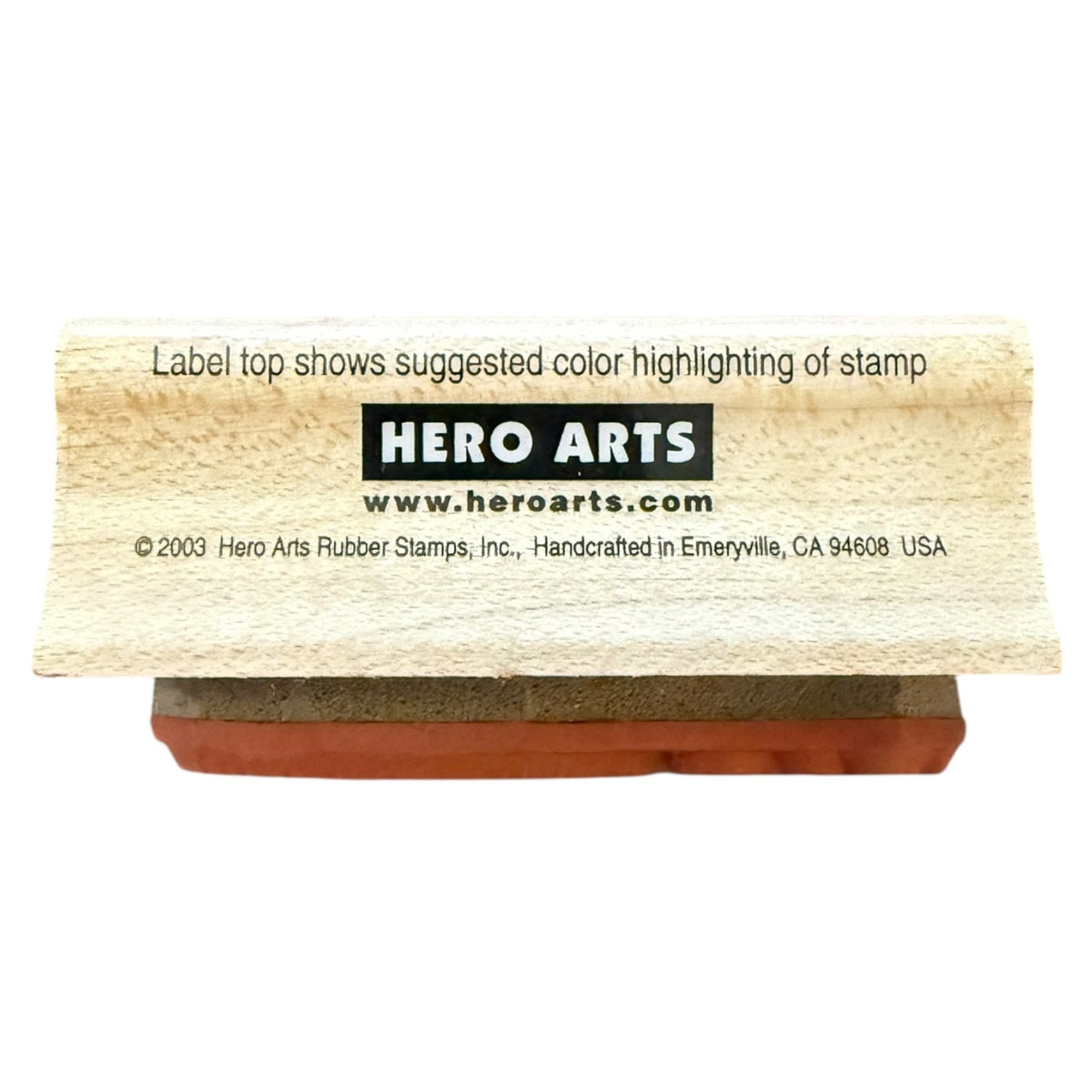 A wooden rubber stamp block , shown on a plain white background. The top has printed text including the brand name HERO ARTS and a suggested color highlight note.