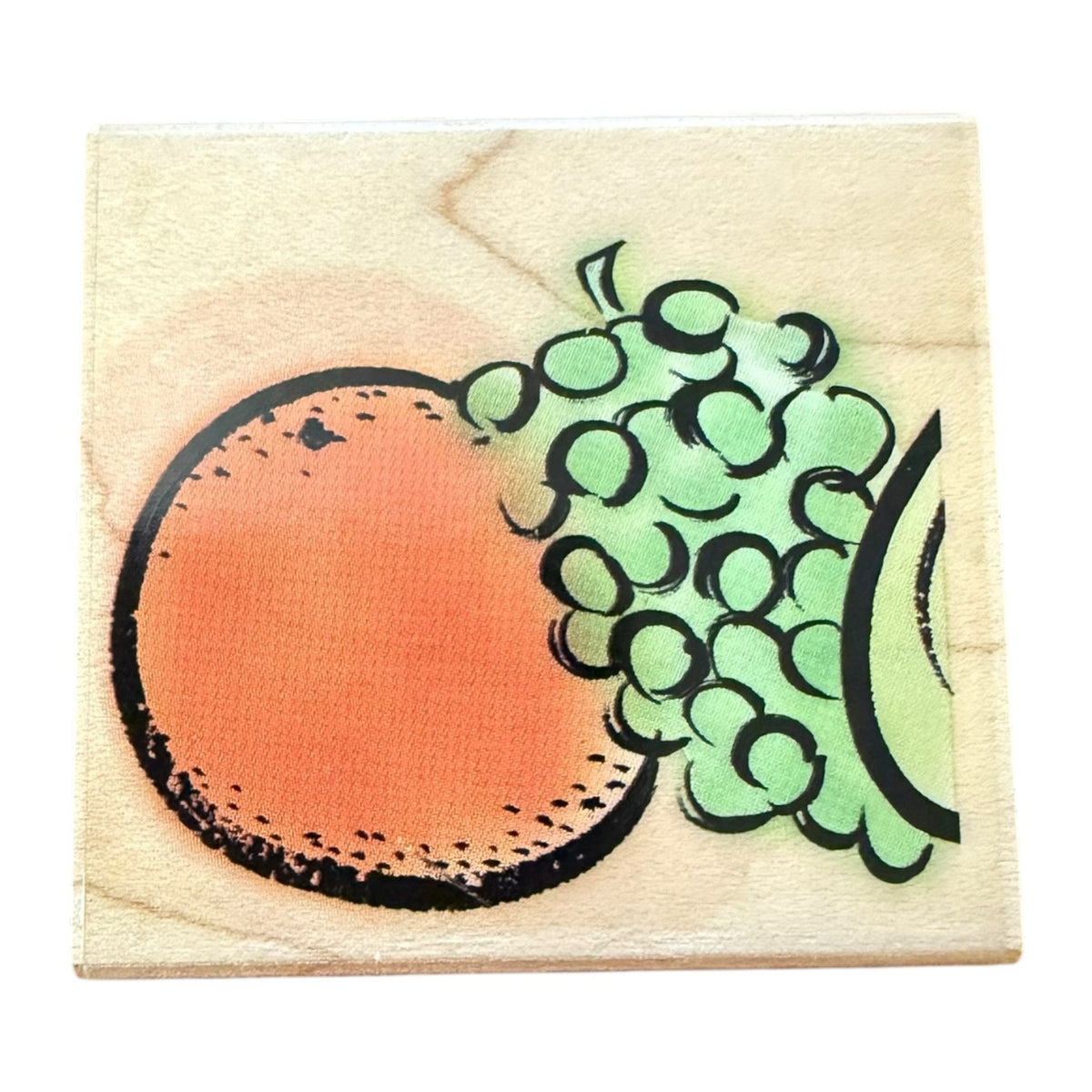 A square wooden stamp block featuring a stylized fruit design with an orange , green grape-like circles, and black outlines, shown on a plain white background.
