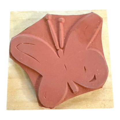 Butterfly-shaped stamp on a wooden block