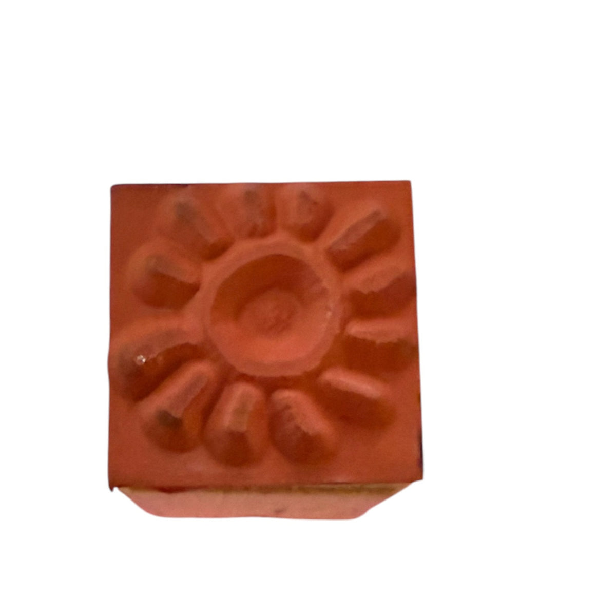 Mounted rubber stamp of a sun on a white background. 