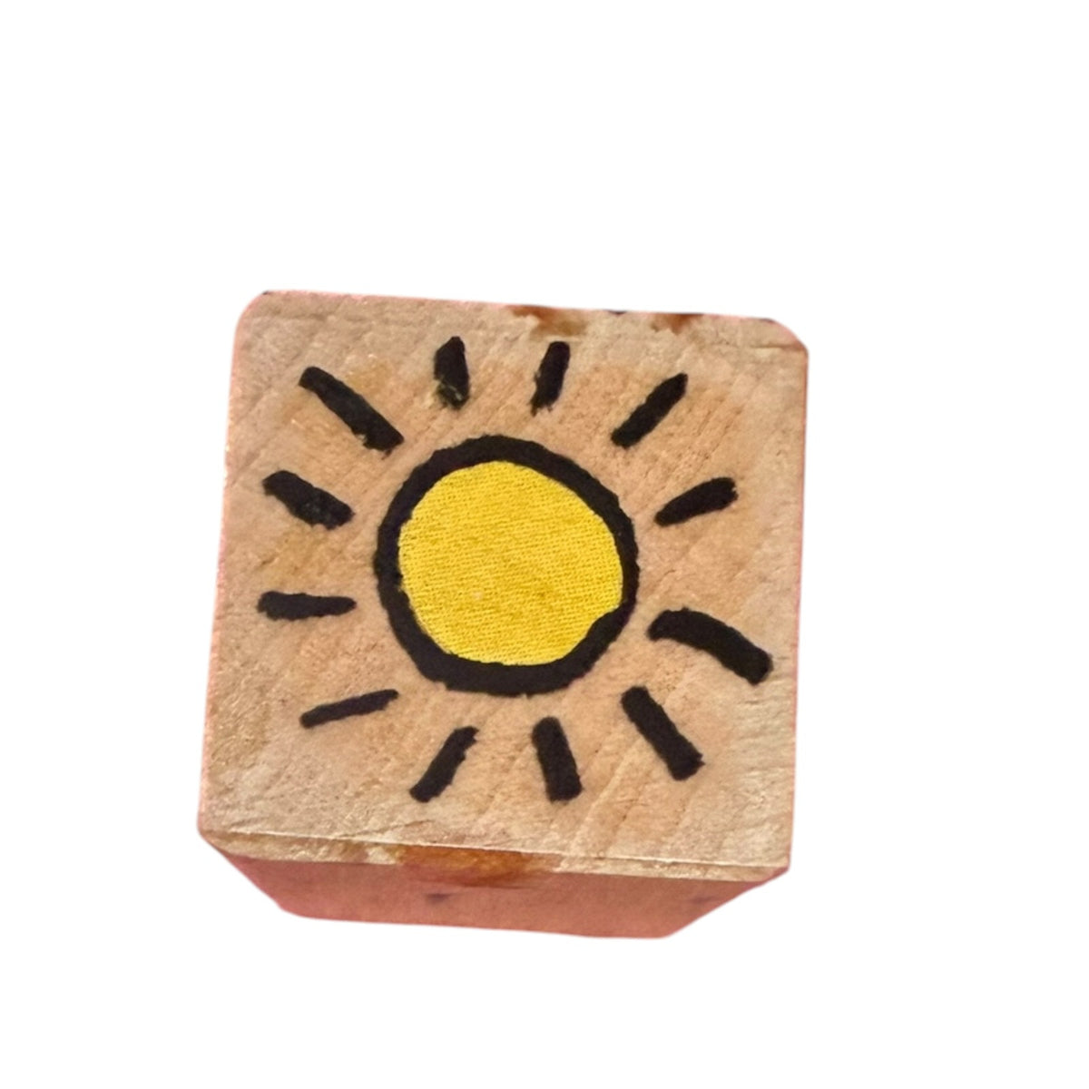 A wood block rubber stamp featuring a sun on a white background. 