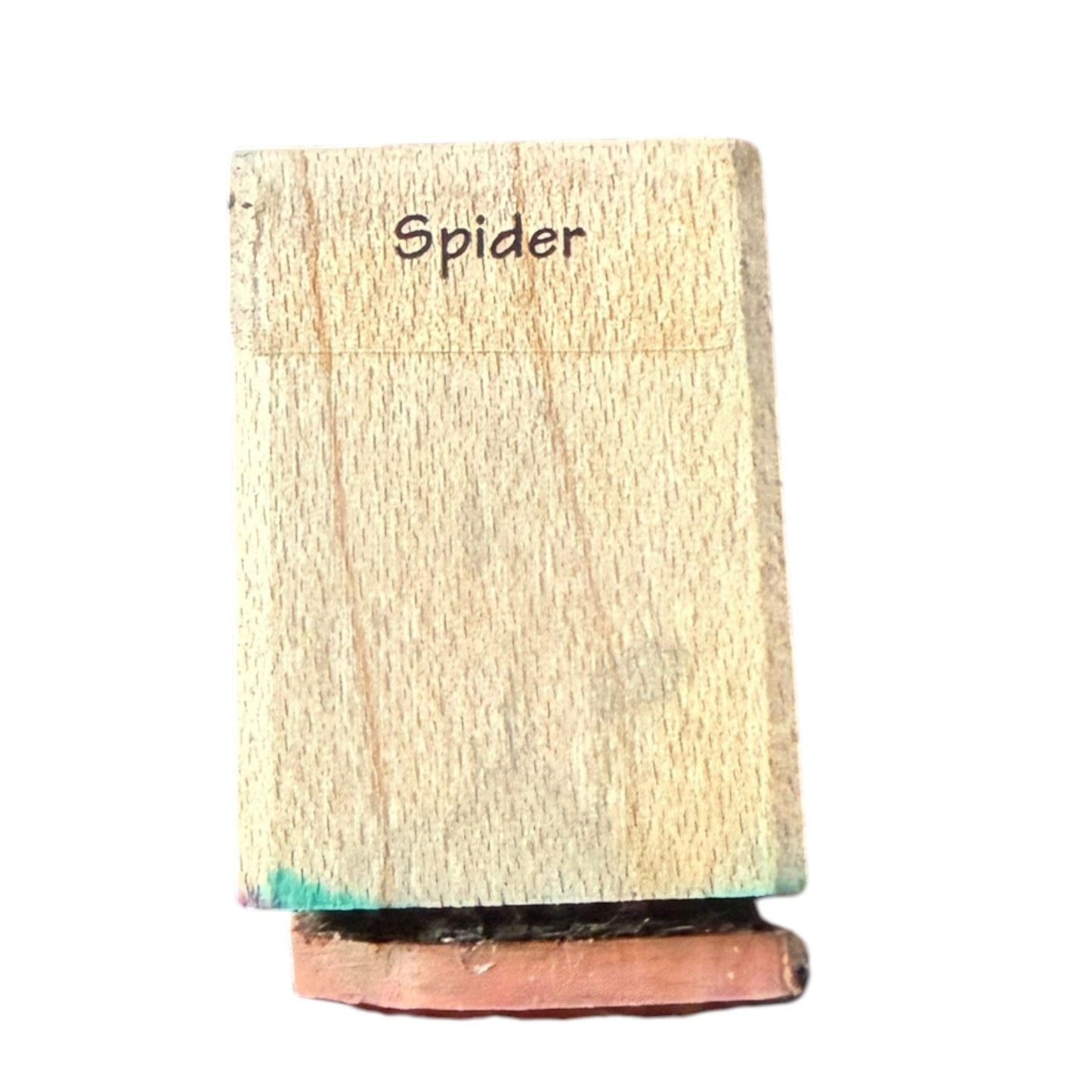 Wooden stamp with 'Spider' text on a white background