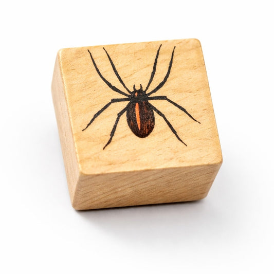 Wooden block with a spider design on a white background