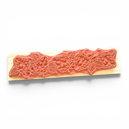 Decorative wooden stamp with fruit pattern on a white background