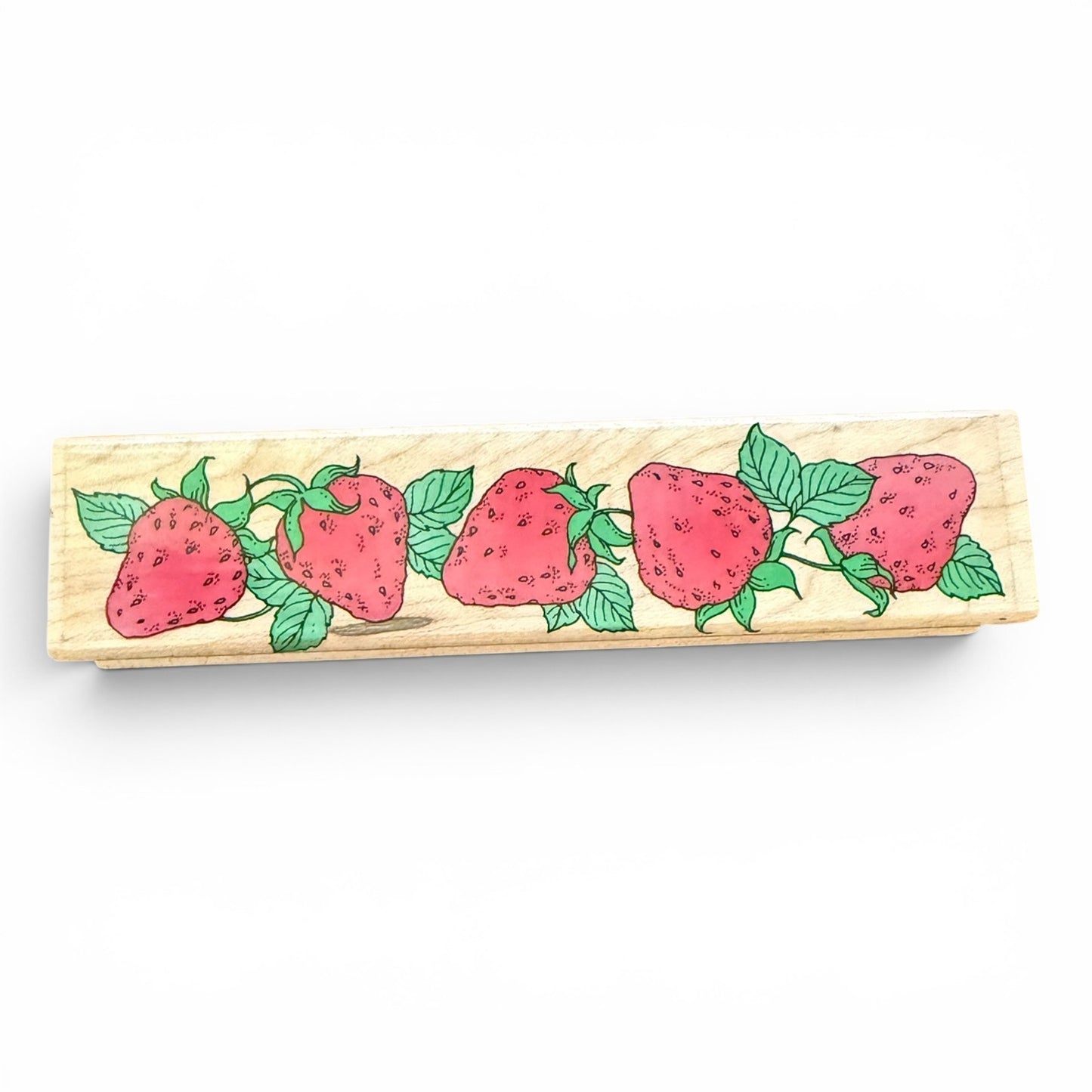 Wooden stamp with strawberry design on a white background