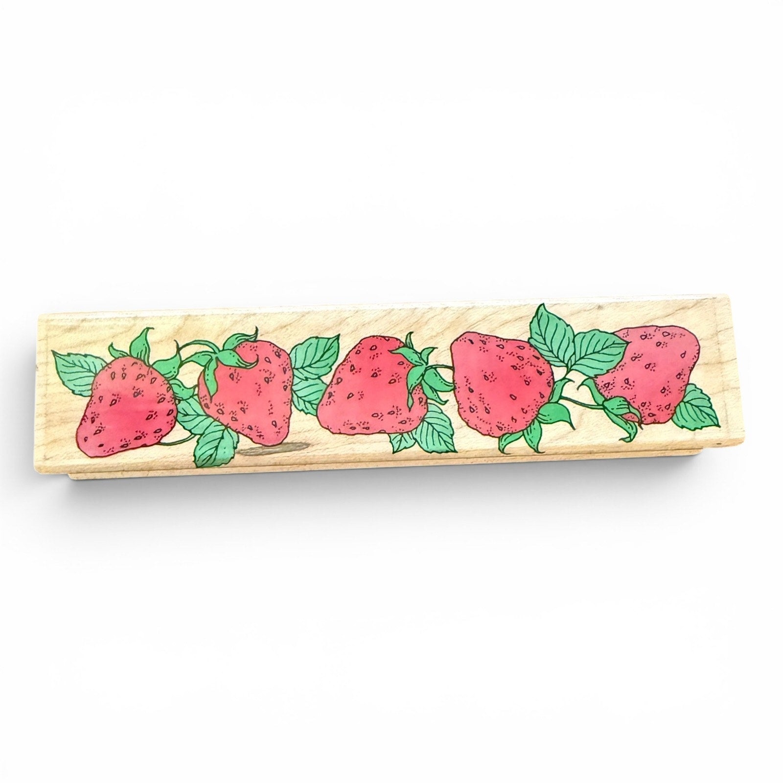 Wooden stamp with strawberry design on a white background