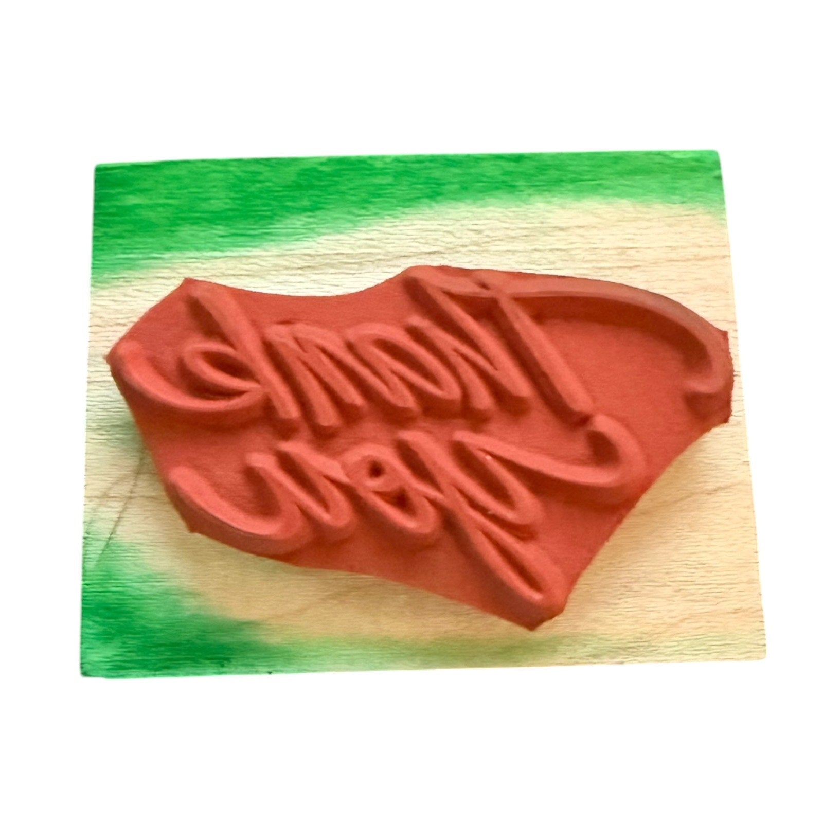 stamp on a wooden block with a colorful stain on block with white background