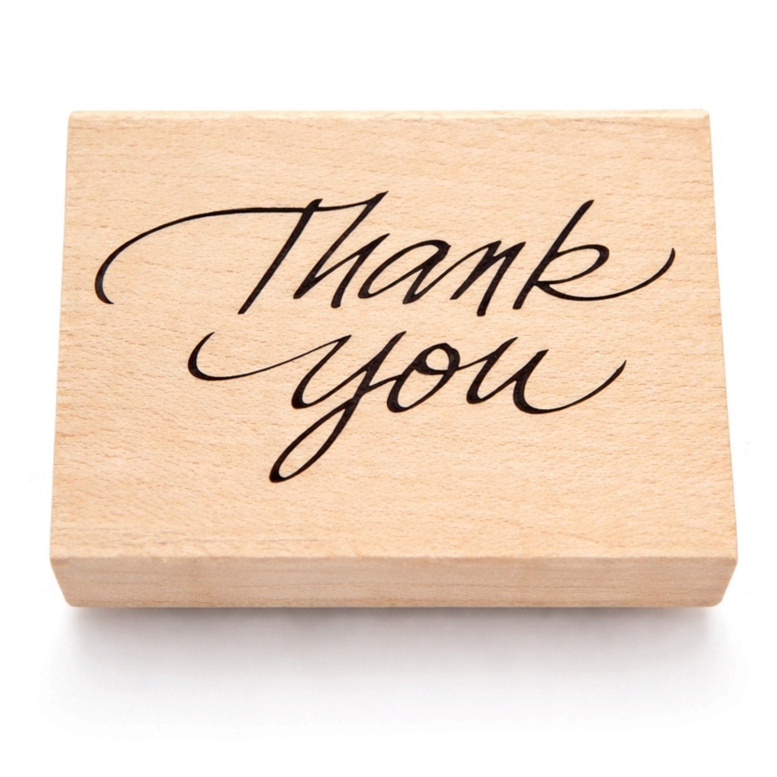Wooden stamp with 'Thank you' text on a white background