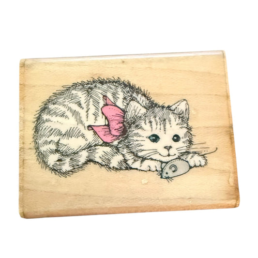 Wooden stamp with a cat and mouse design on a white background
