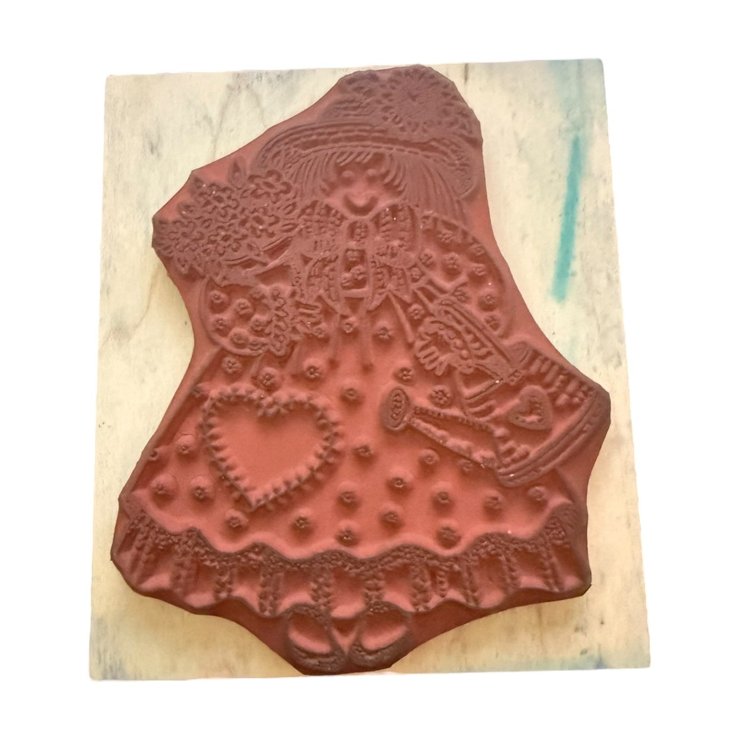 Decorative wooden stamp with intricate patterns on a wooden block