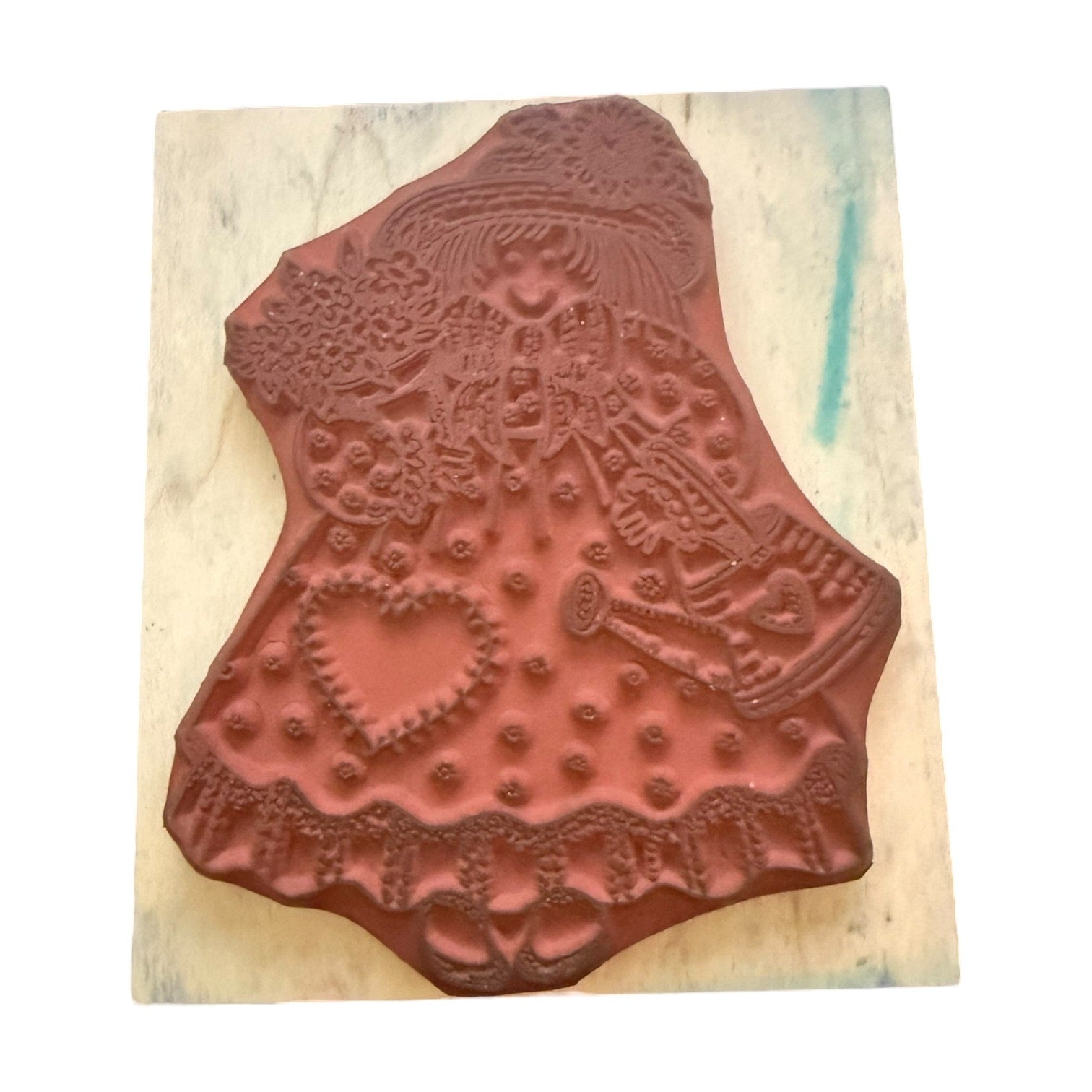 Decorative wooden stamp with intricate patterns on a wooden block
