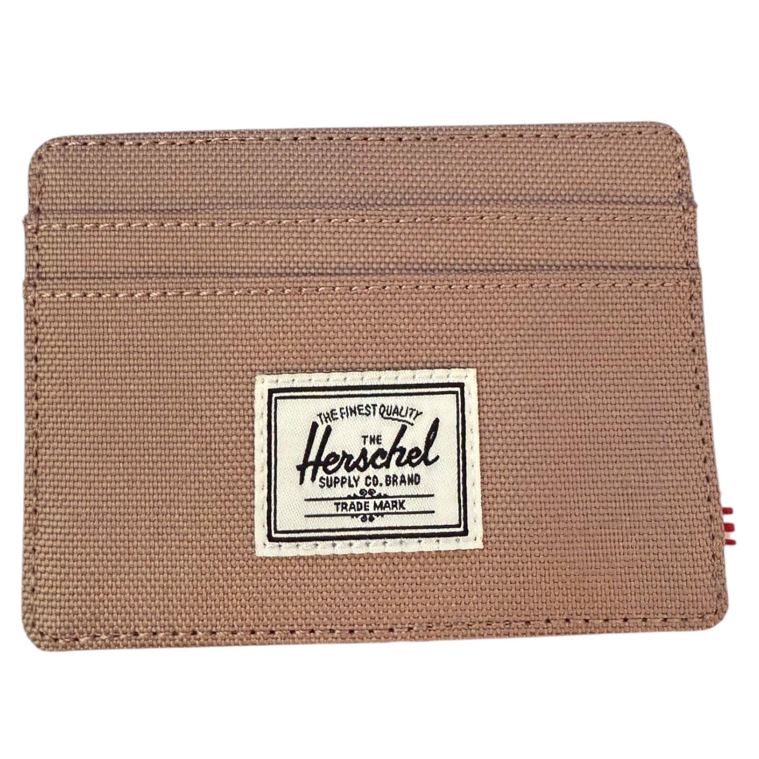 Beige wallet with Herschel Supply Co. label on a white background