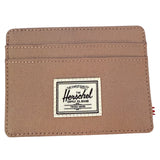 Beige wallet with Herschel Supply Co. label on a white background