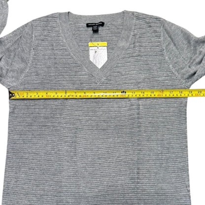 Gray sweater with a measuring tape around it on a white background