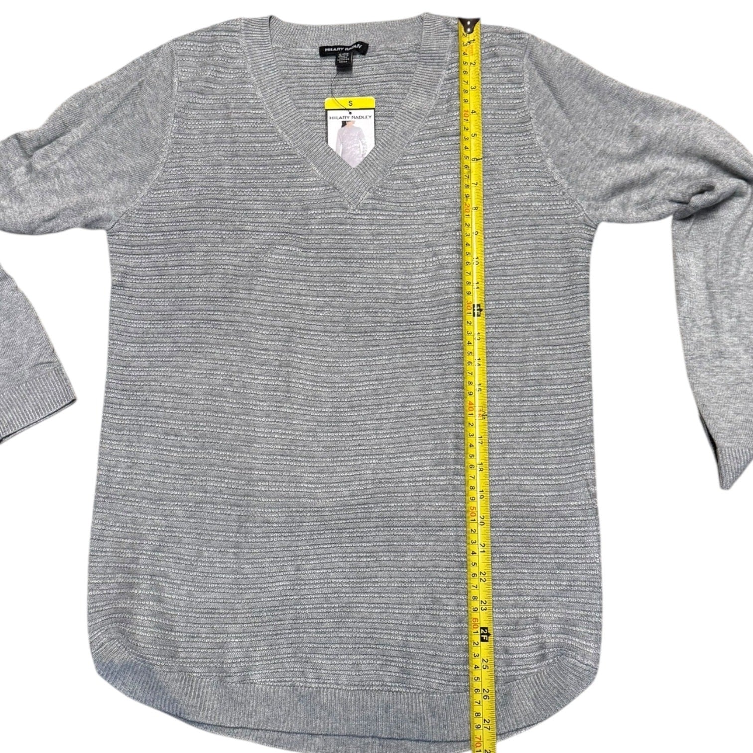 Gray sweater with a measuring tape on a white background