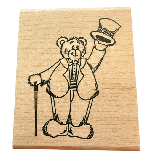 Wooden stamp with a bear design wearing a top hat and coat on a white background