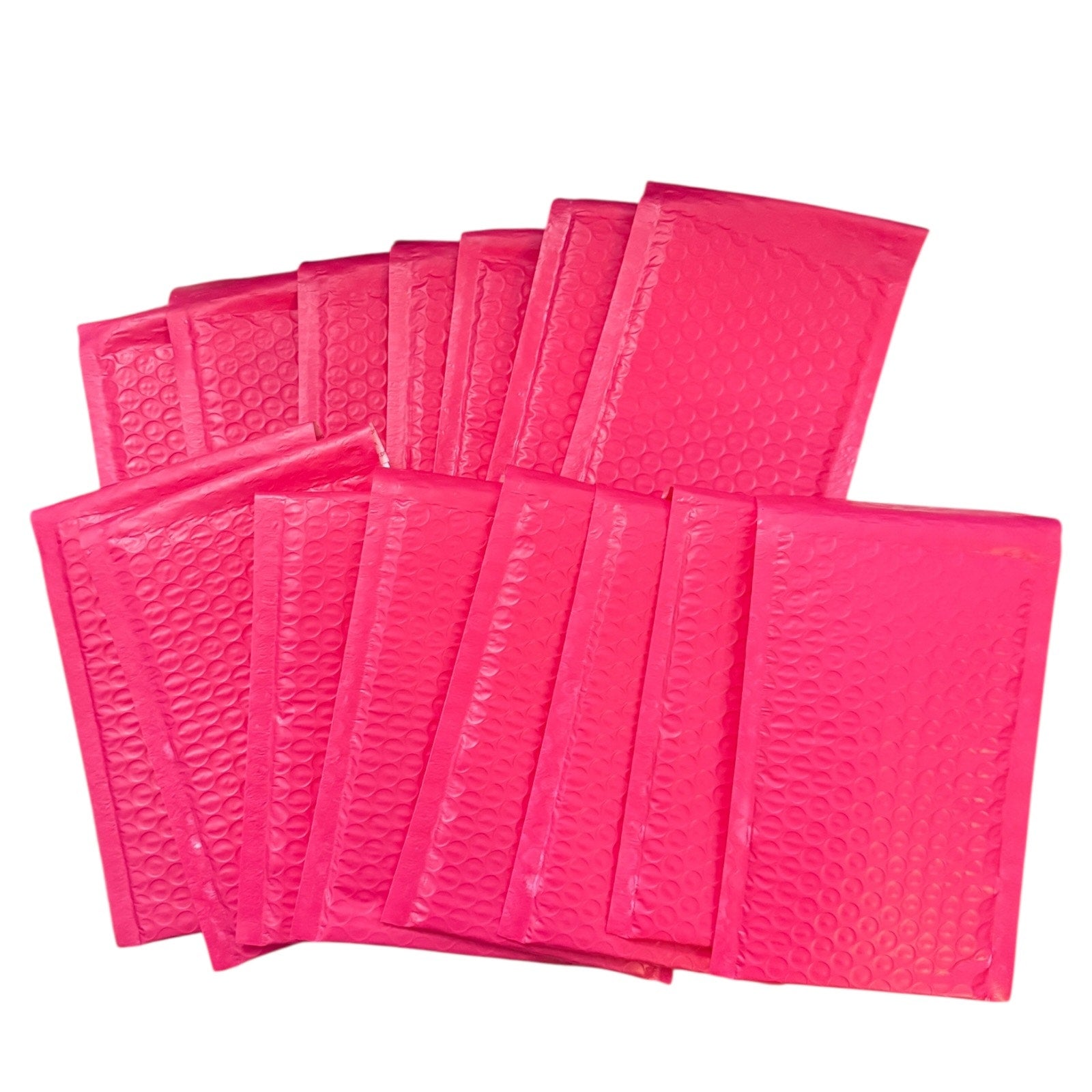 Pink bubble mailers arranged on a white background