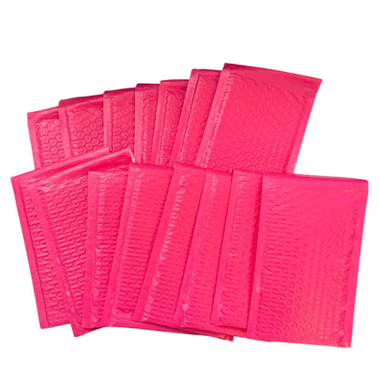 Pink bubble mailers arranged on a white background