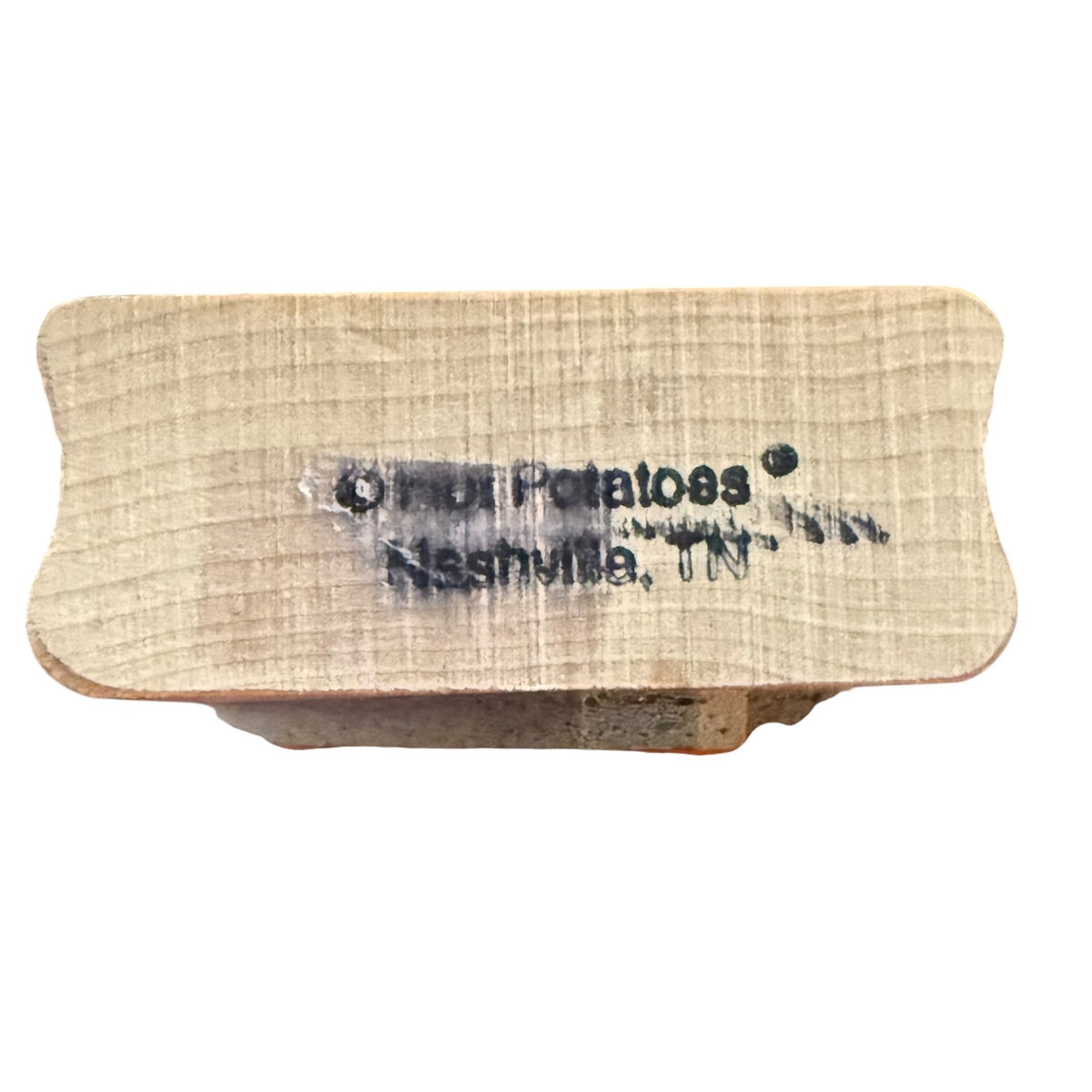 A square wooden block stamp with rounded corners, featuring the words 'Hot Potatoes Nashville, TN' printed in black ink on a light wood surface.