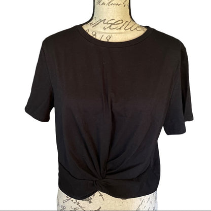 Front of Black t-shirt on a mannequin with a white background