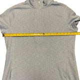 Blue dress with a measuring tape across it on a white background