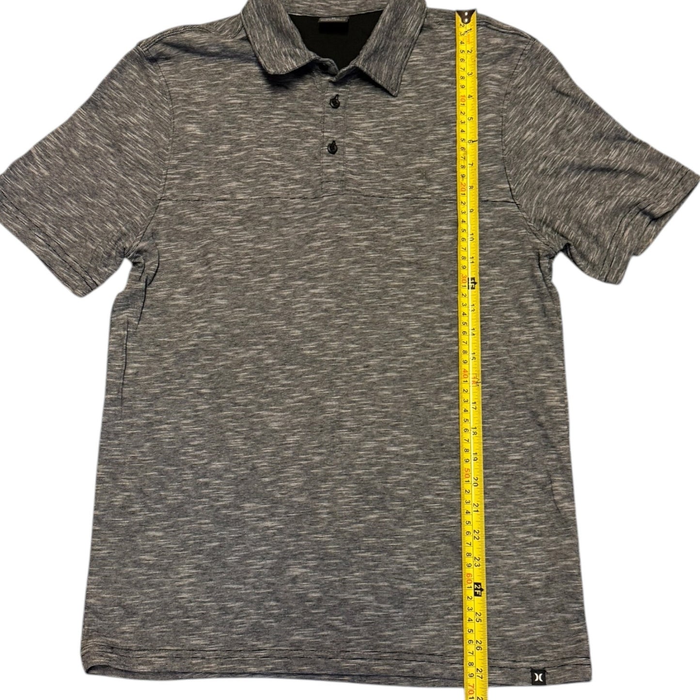 Black white polo shirt with a measuring tape on a white background