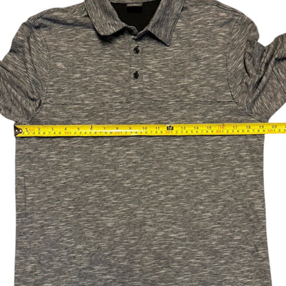 Black white polo shirt with a measuring tape across it on a white background