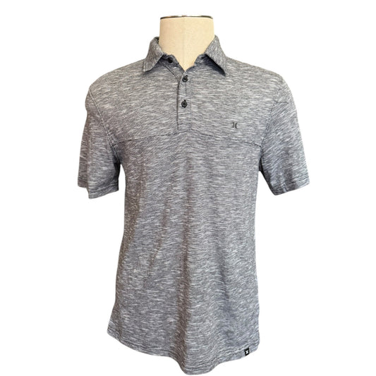 black white patterned polo shirt on a mannequin against a white background