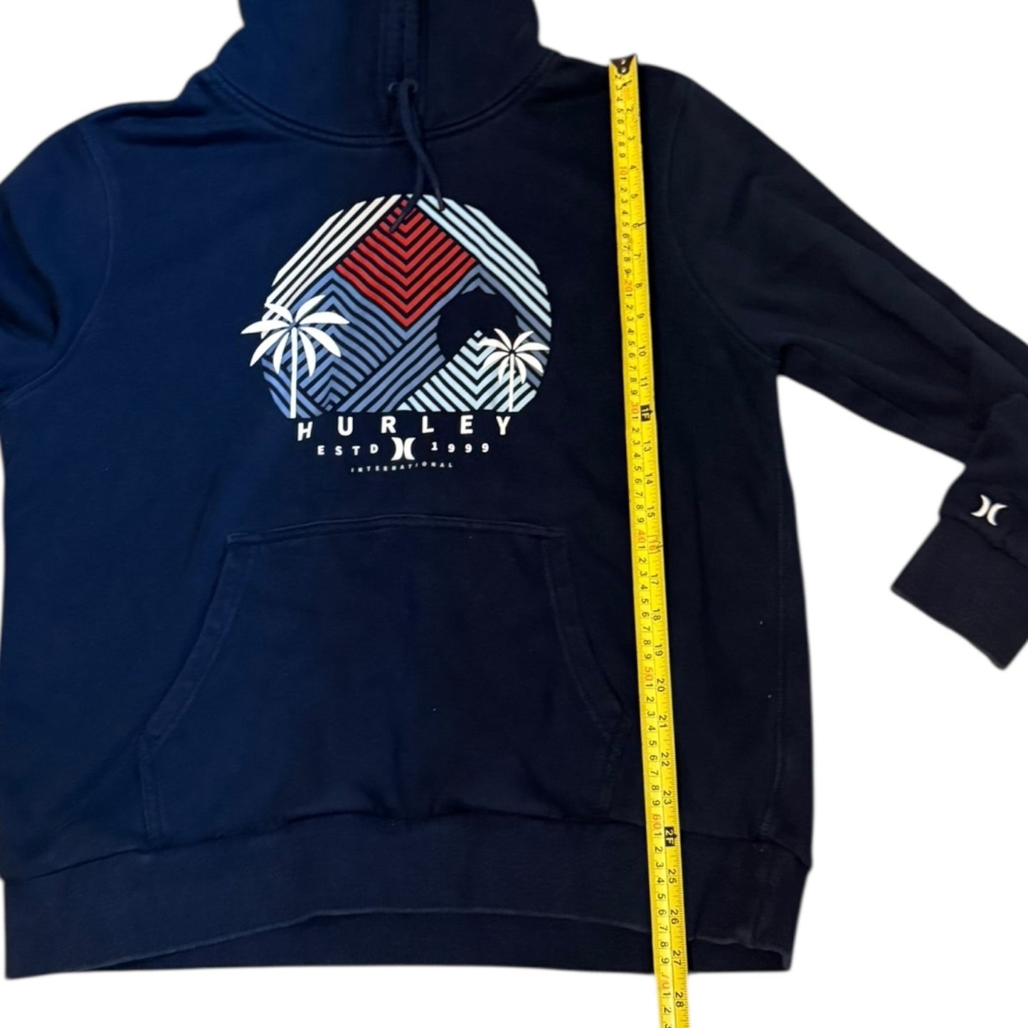 blue hoodie with a colorful graphic and 'Hurley' branding, measured with a yellow tape measure.