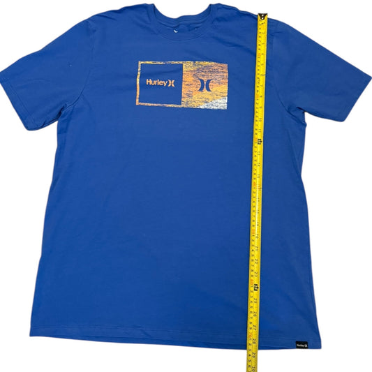 Blue t-shirt with aHurley logo measurement by a tape measure on a white background