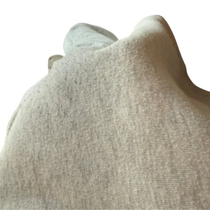 Close-up of a textured gray pilling on fabric surface