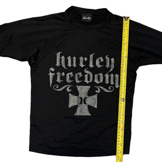 Black rashguard with 'Hurley Freedom' logo and a measuring tape on a white background