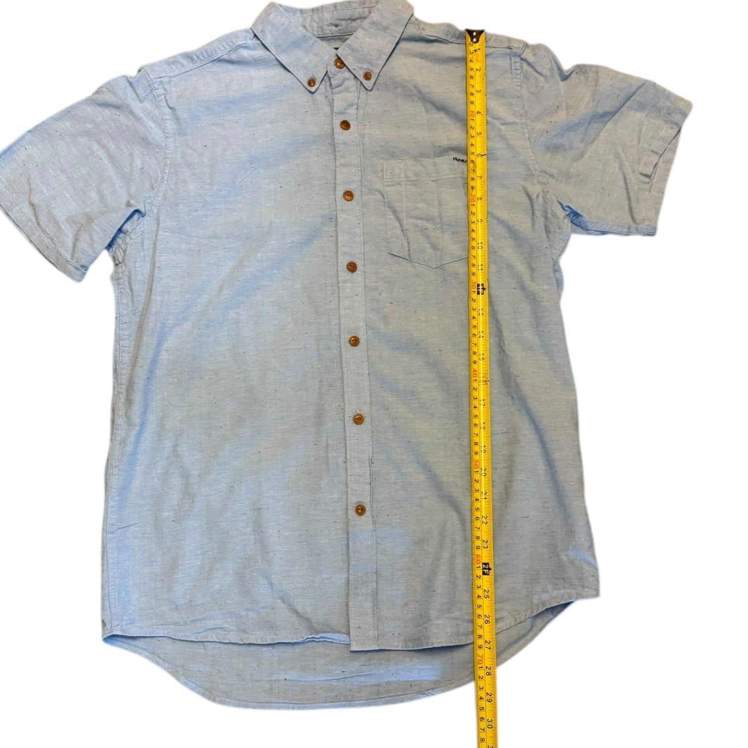Short-sleeve button-up shirt with a measuring tape for size reference on a white background