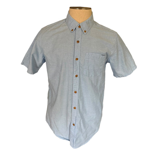Light blue short-sleeve shirt on a mannequin with a white background